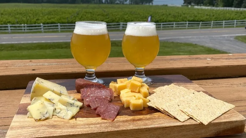Two craft beers with a charcuterie board at Watershed Brewing