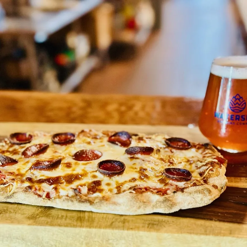House-made flatbread pizza with a Watershed beer
